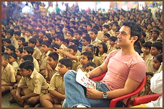 Aamir watches as the kids put on a show