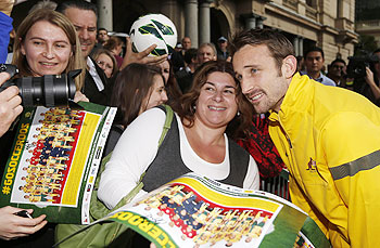 Australia's player Josh Kennedy poses for pictures with fans during an event to celebrate their World Cup qualification in central Sydney on Wednesday