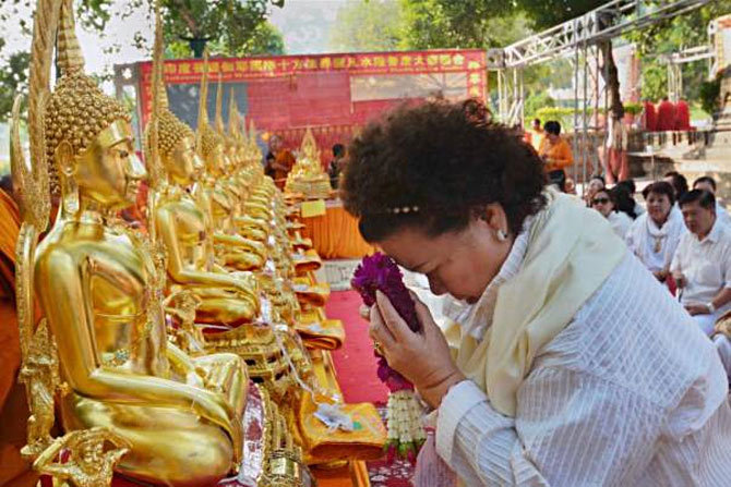 A Buddhist devotee from Thailand offers prayers at the Mahabodhi temple in Bodh Gaya