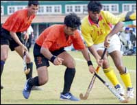 BPCL defender Ajay Saroda tackles ONGC forward Amit Kumar.