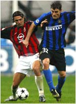 Paolo Maldini (L) is challenged by Christian Vieri 