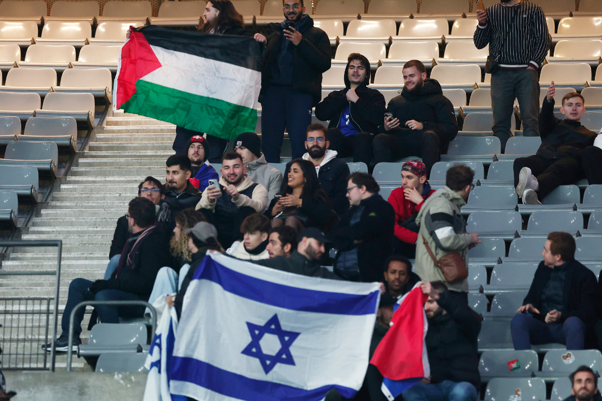 Fans at the Nations League match between France v Israel in Paris, display a Palestine flag and an Israel flag amid the ongoing conflict between Israel and Hamas 